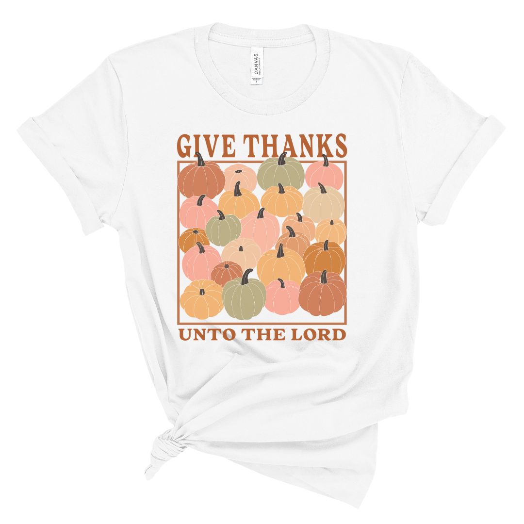 White t-shirt with colorful pumpkins and 'Give Thanks Unto The Lord' text on a white background