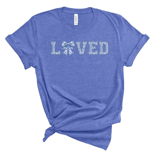 t-shirt with the word 'LOVED' printed in blue chinoiserie-style lettering.