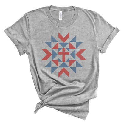 Christian women’s t shirt with vintage red white and blue quilt star pattern surrounding a cross design, patriotic faith based summer graphic tee.