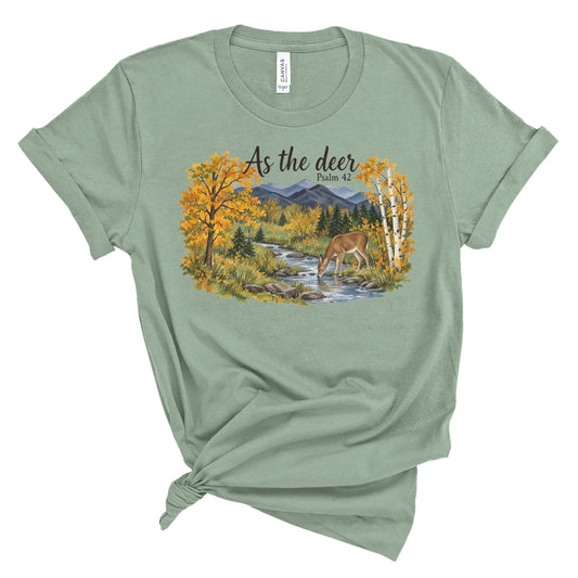 shirt with a watercolor style deer drinking from a creek, golden fall trees, evergreens, and mountains beneath “As the deer” and “Psalm 42.”