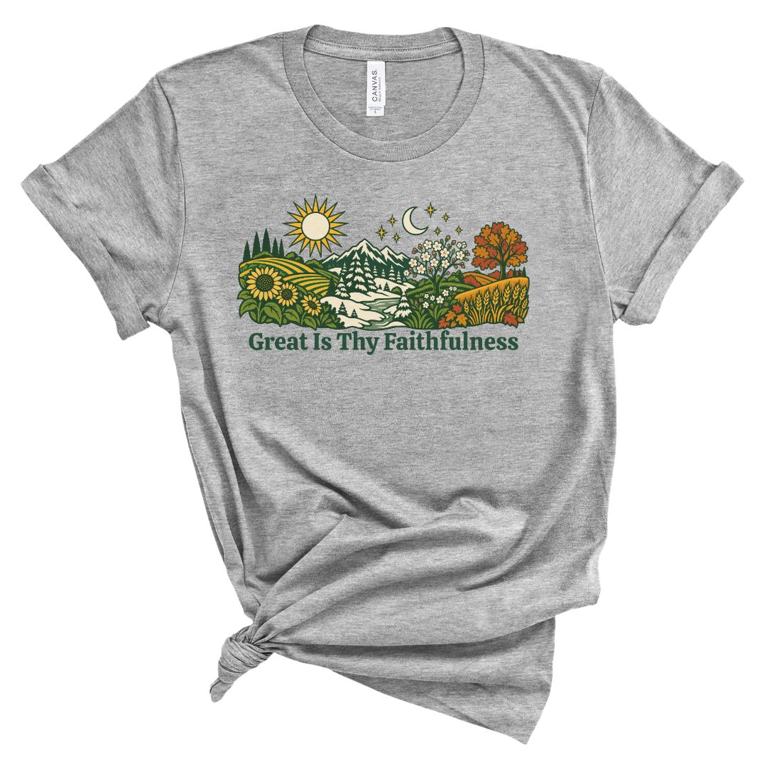 tee with colorful birds, flowers, evergreens, mountains, snowflakes, sun, moon, and the words “Great Is Thy Faithfulness”