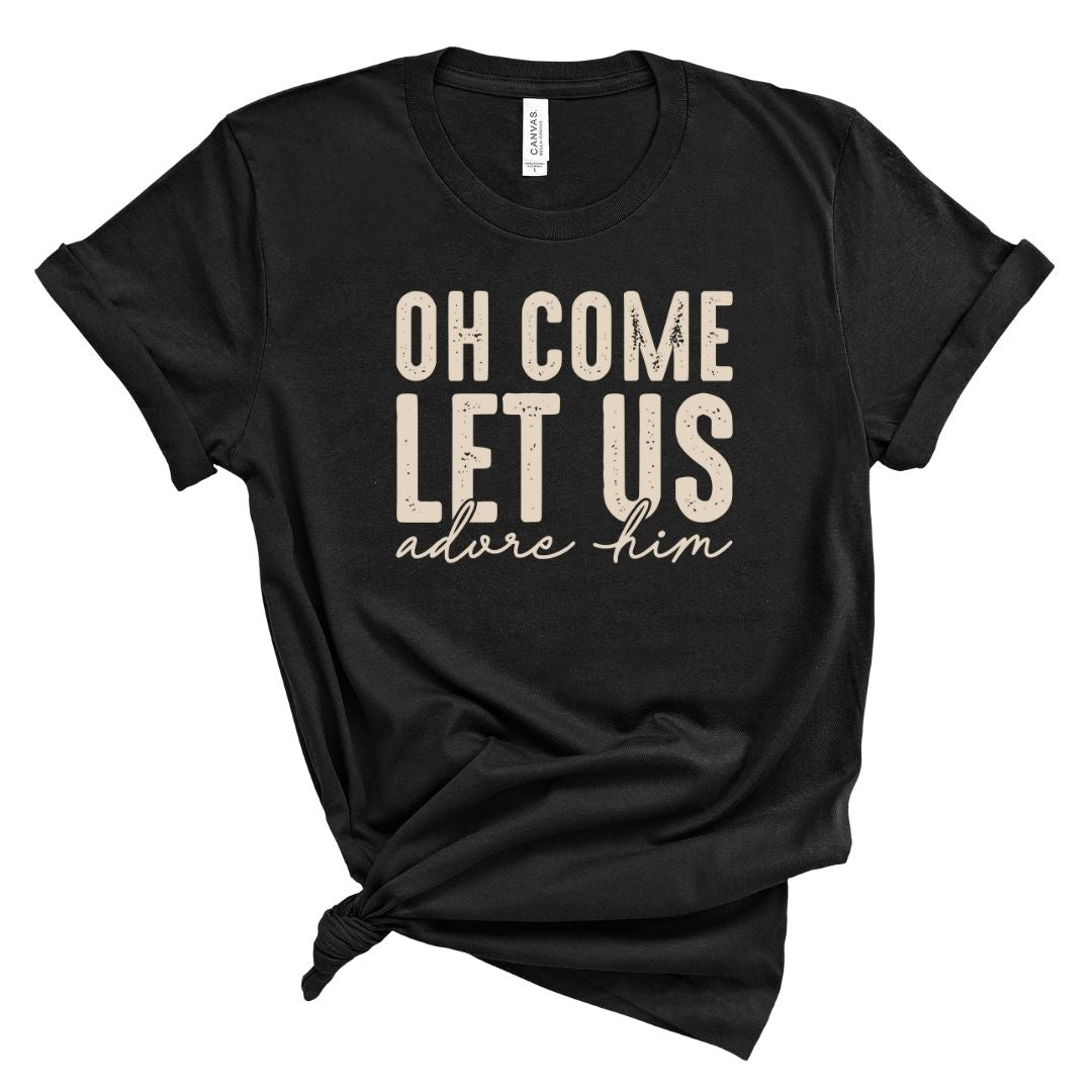 Black t-shirt with white text 'OH COME LET US adore him' on a white background