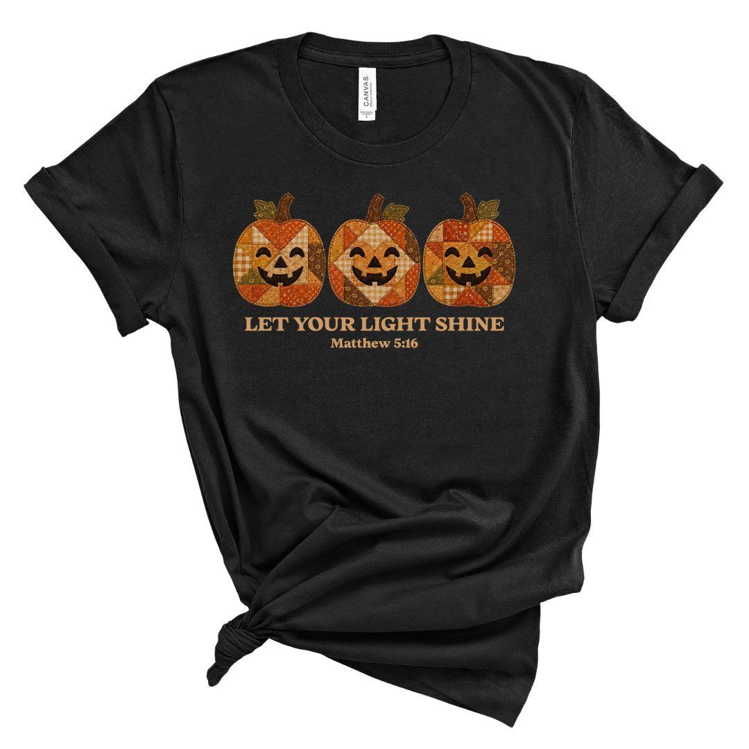 Christian shirt for women with three faux applique patchwork style pumpkins and “Let Your Light Shine, Matthew 5:16.” Printed design, not real fabric applique.