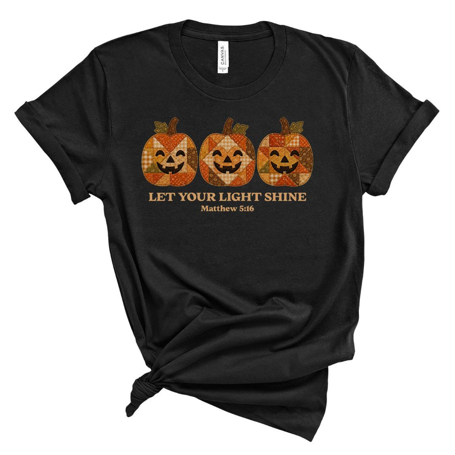 Christian shirt for women with three faux applique patchwork style pumpkins and “Let Your Light Shine, Matthew 5:16.” Printed design, not real fabric applique.