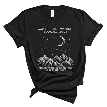 Black t-shirt with mountain and celestial design with text wathcing and waiting looking above