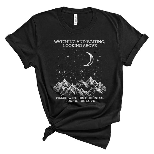 Black t-shirt with mountain and celestial design with text wathcing and waiting looking above