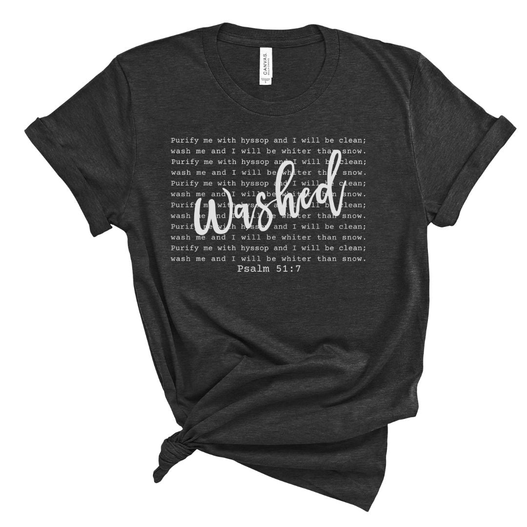 Black Christian women’s t-shirt with the word “Washed” in white script lettering layered over repeated Psalm 51:7 scripture text. Simple faith-based tee with a soft, relaxed silhouette.