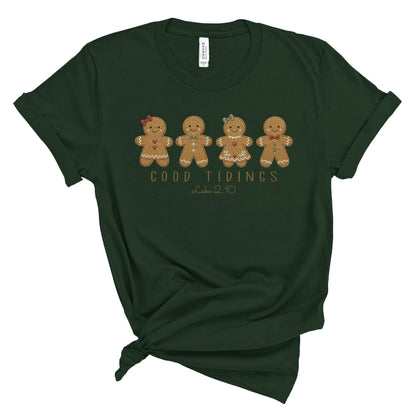 Christian Christmas tee with four gingerbread characters in a printed faux embroidery style, with Good Tidings and Luke 2:10 underneath.