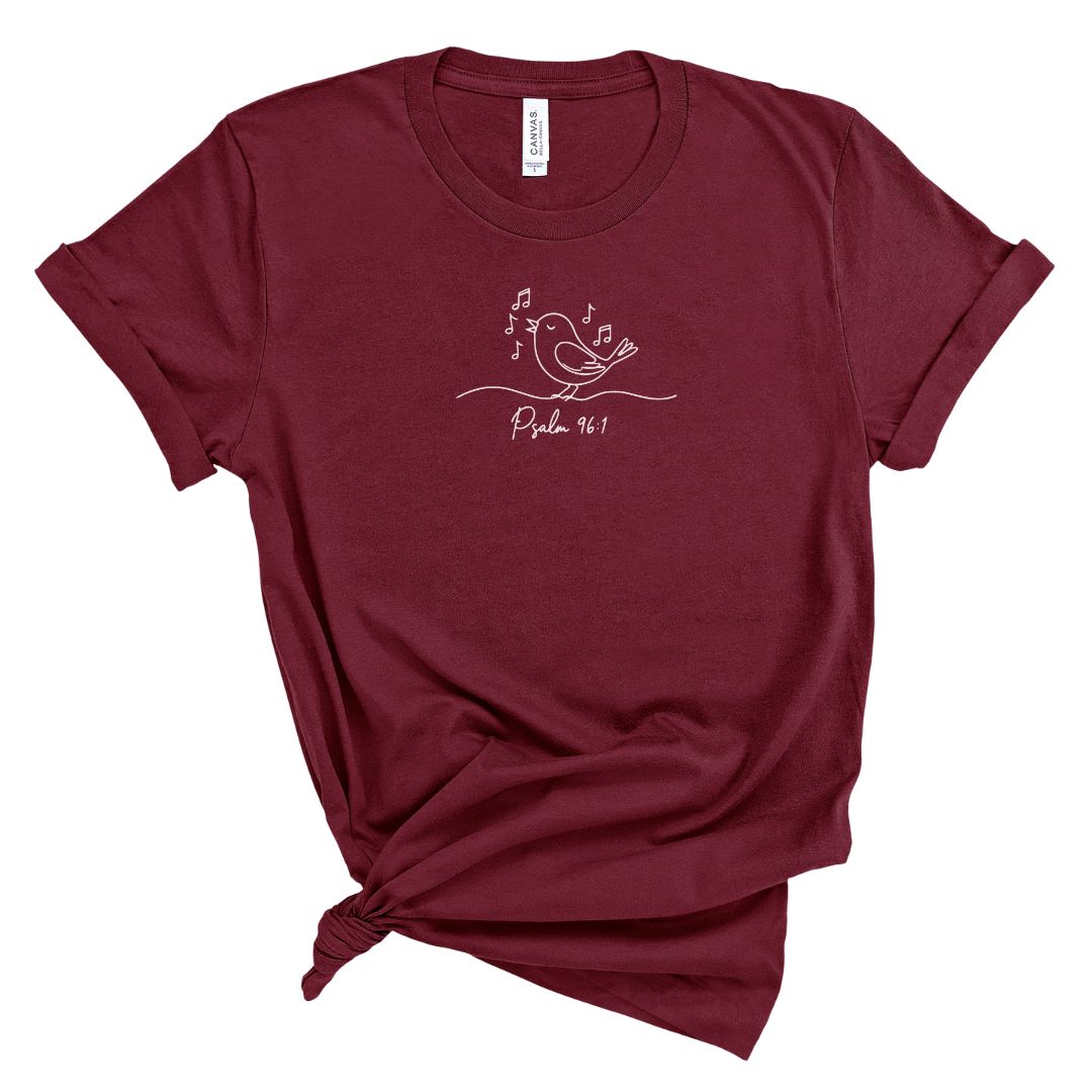 Maroon t-shirt with a bird and musical notes and text psalm 96: design on a white background