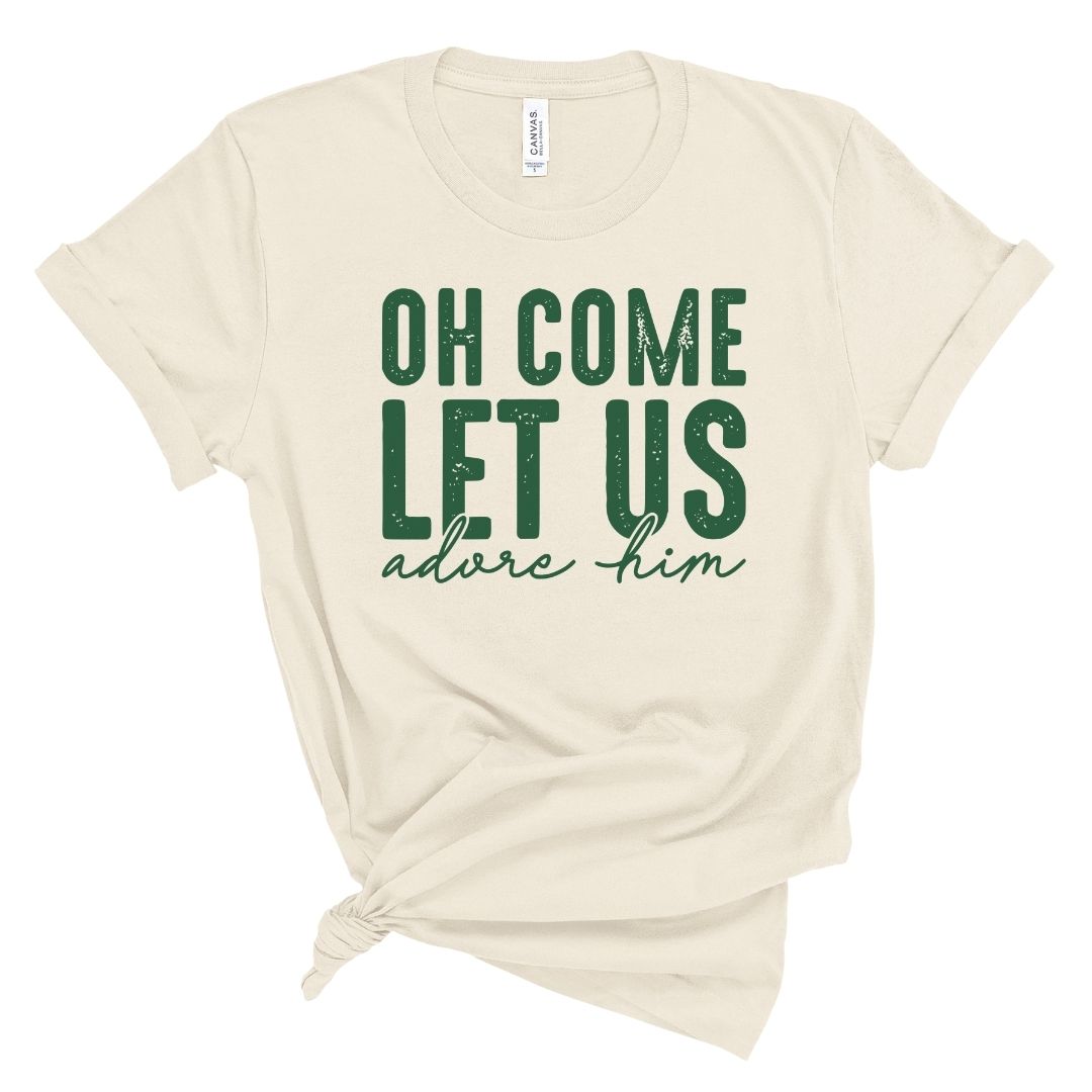 Beige t-shirt with green text 'Oh come let us adore him' on a white background