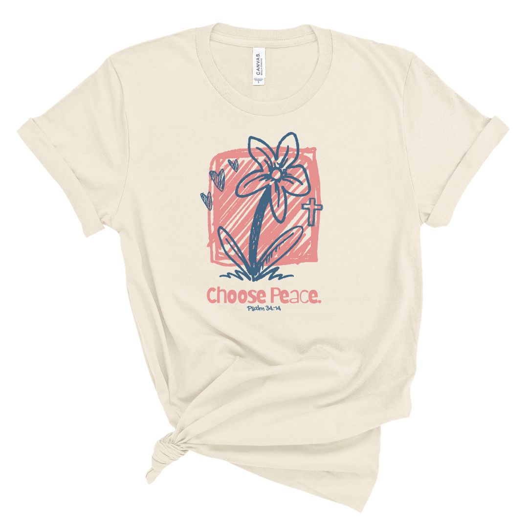 Christian t shirt with hand drawn flower and cross design with Choose Peace Psalm 34:14 text in pink and blue