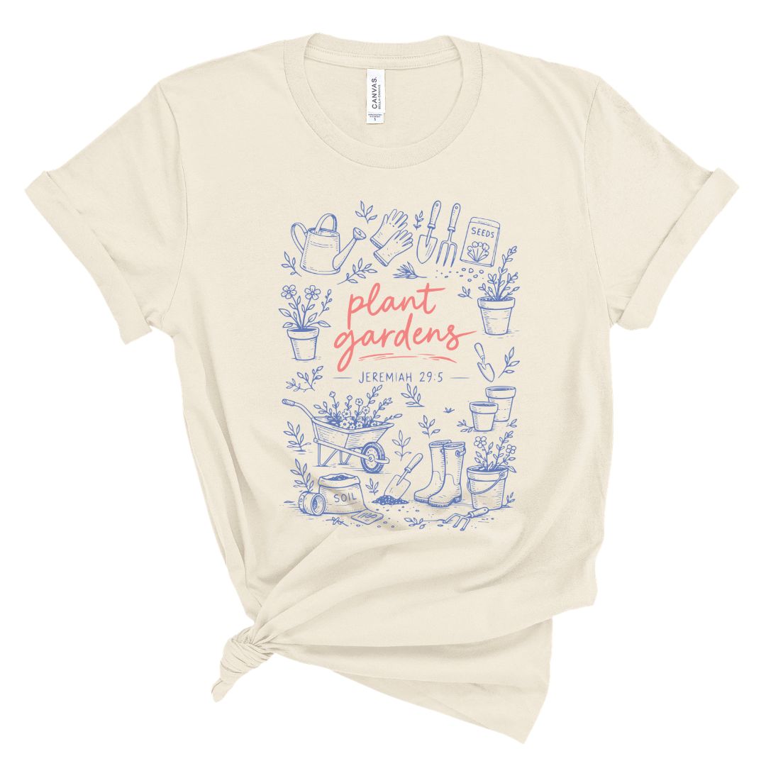 Christian t shirt with blue garden illustrations and coral text reading plant gardens Jeremiah 29:5, Bible verse gardening shirt for women