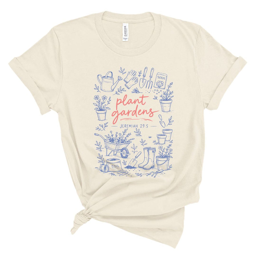 Christian t shirt with blue garden illustrations and coral text reading plant gardens Jeremiah 29:5, Bible verse gardening shirt for women