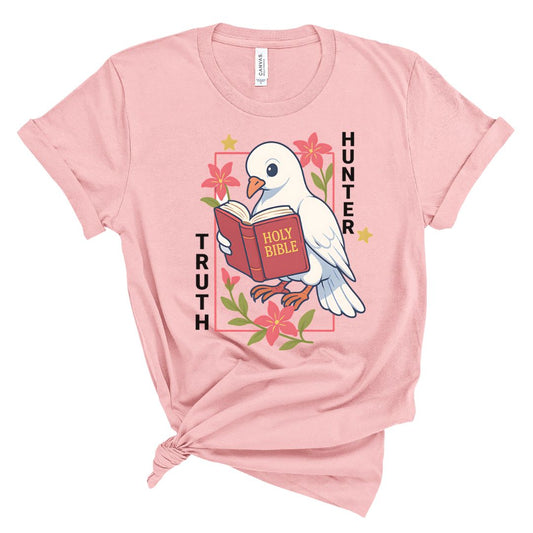 Pink t-shirt with a dove holding a Bible and floral design on a white background
