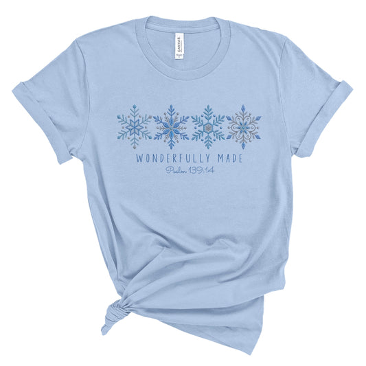 Christian tee with four detailed snowflakes in a blue printed faux embroidery style, with Wonderfully Made and Psalm 139:14 underneath.