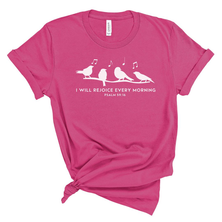 A pink t-shirt with a graphic that includes a bird and the text 'I will rejoice every morning PSALM 59:16'.