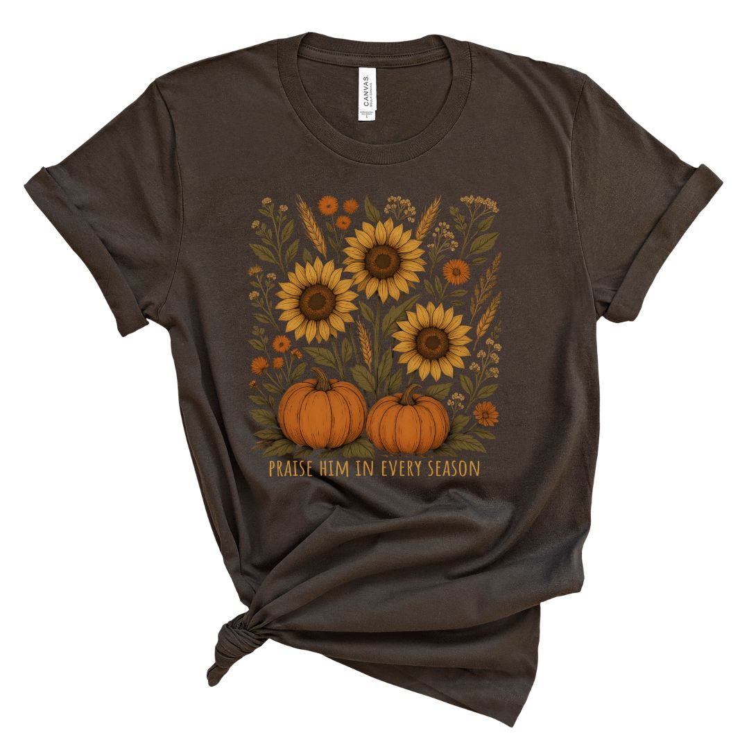 Brown t-shirt with sunflowers and pumpkins design and text that says Praise him in every season