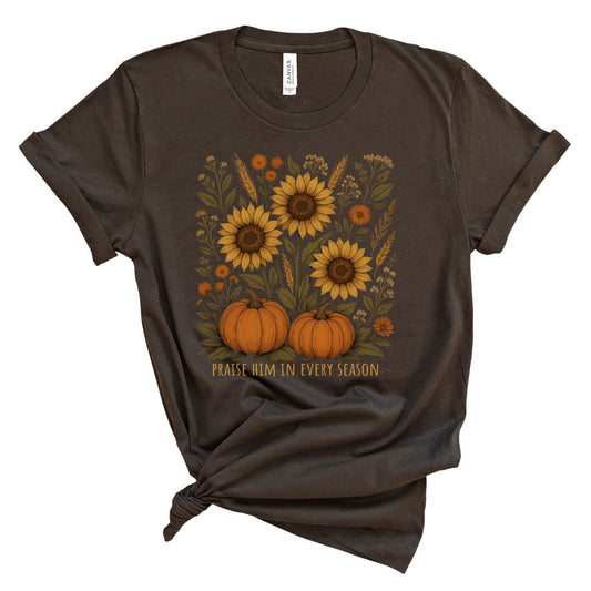 Brown t-shirt with sunflowers and pumpkins design and text that says Praise him in every season