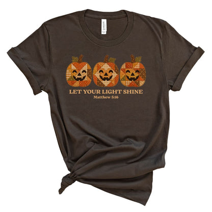 Christian shirt for women with three faux applique patchwork style pumpkins and “Let Your Light Shine, Matthew 5:16.” Printed design, not real fabric applique.