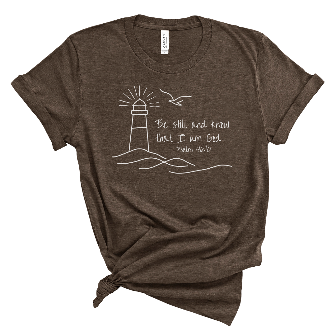 Christian t shirt for women with Psalm 46 10 Be still and know that I am God, lighthouse and ocean waves design, faith based Bible verse tee for everyday wear