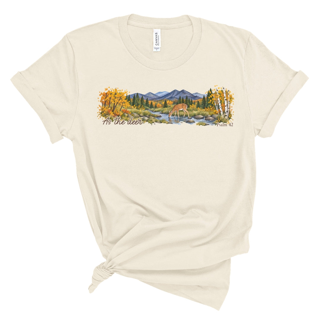 shirt with a wide watercolor style mountain landscape, golden trees, a deer drinking from a rocky creek, and “As the deer” and “Psalm 42.”