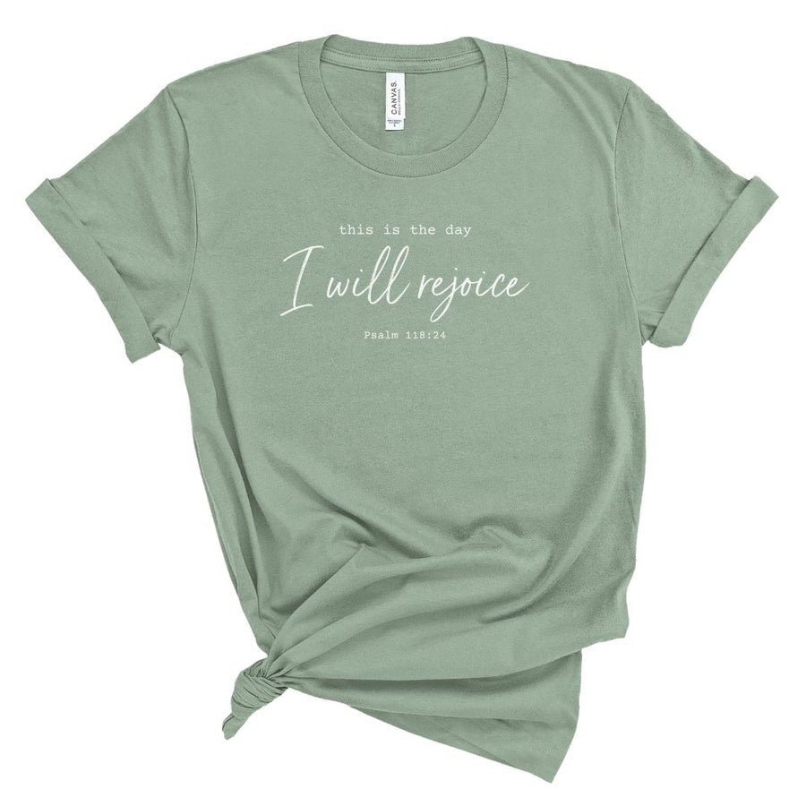 Christian shirt for women featuring the words This Is the Day I Will Rejoice with Psalm 118:24 in white lettering on a folded tee.