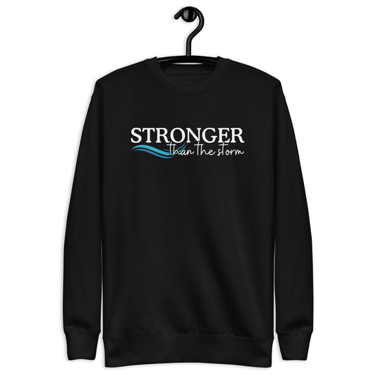 Sweatshirt with the text stronger than the storm and an image of a wave