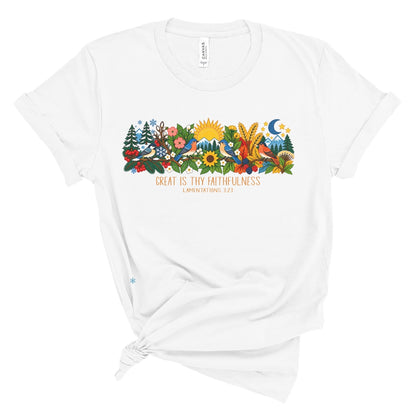 tee with colorful birds, flowers, evergreens, mountains, snowflakes, sun, moon, and the words “Great Is Thy Faithfulness” and “Lamentations 3:23.”
