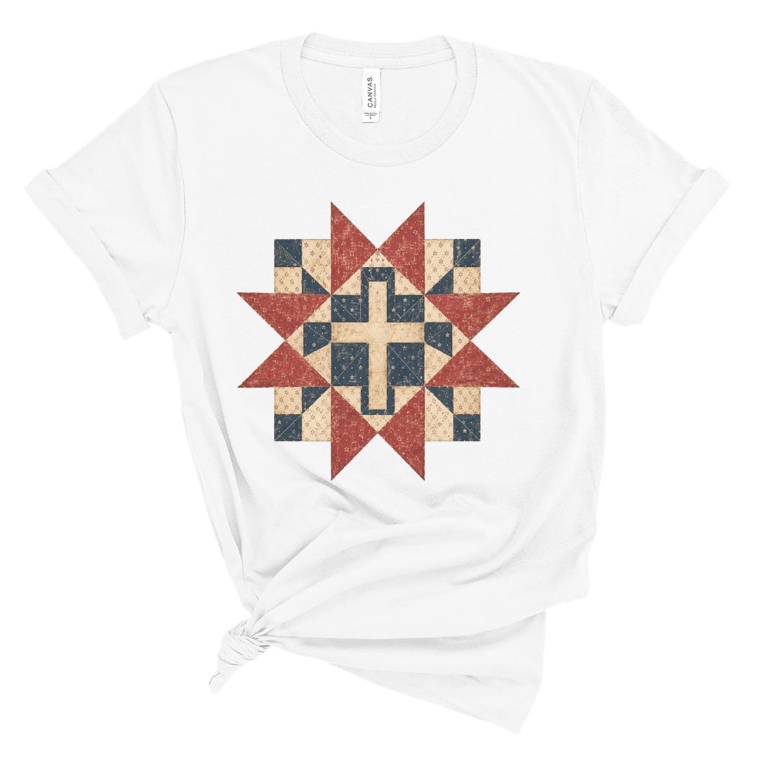 Christian women’s t shirt with vintage red white and blue quilt star pattern surrounding a cross design, patriotic faith based summer graphic tee.
