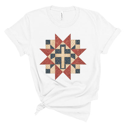 Christian women’s t shirt with vintage red white and blue quilt star pattern surrounding a cross design, patriotic faith based summer graphic tee.