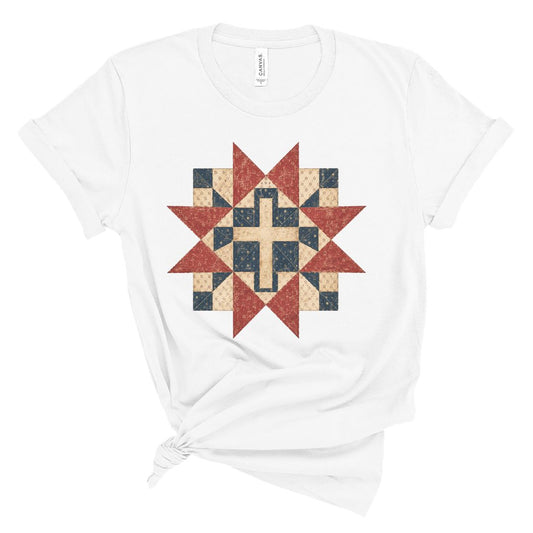 Christian women’s t shirt with vintage red white and blue quilt star pattern surrounding a cross design, patriotic faith based summer graphic tee.