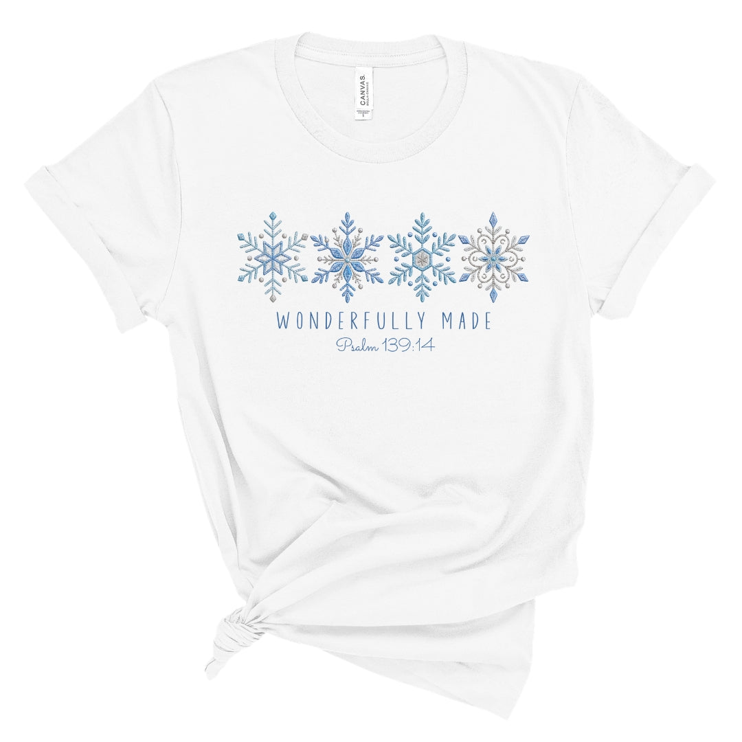 Christian tee with four detailed snowflakes in a blue printed faux embroidery style, with Wonderfully Made and Psalm 139:14 underneath.