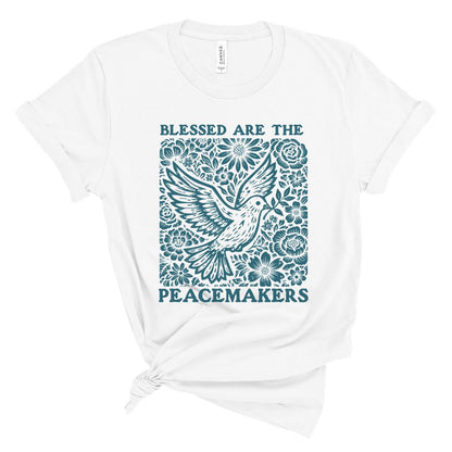 Christian t shirt for women with teal dove and floral design and the words Blessed Are the Peacemakers in bold lettering.
