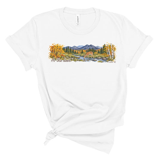 shirt with a wide watercolor style mountain landscape, golden trees, a deer drinking from a rocky creek, and “As the deer” and “Psalm 42.”